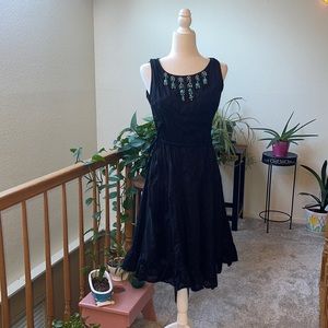 S.L. fashions black dress with turquoise beaded neck line.